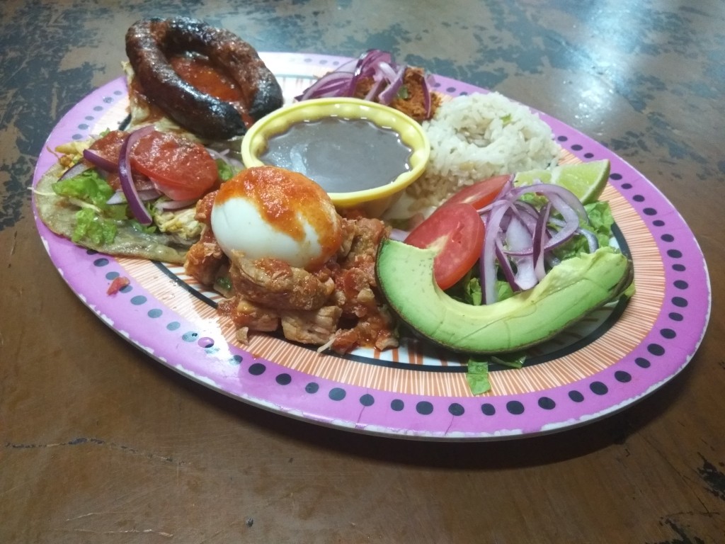 Plato winik with cochinita, lomitos, poc-chuc, longaniza asada, panuchos; served with a boiled egg, avocado, salad and frijoles. Plato winik with cochinita, lomitos, poc-chuc, longaniza asada, panuchos; served with a boiled egg, avocado, salad and frijoles.