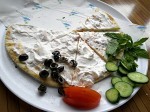 Manouche with labneh accompanied by greens and fresh peppermint leaves