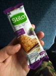 A crunchy cereal bar with oats and with a blackberry filling.