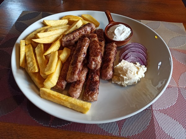 Montenegrin Ćevapi with cream and fries Montenegrin Ćevapi with cream and fries