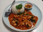 Red curry paste with fried young coconut and basil leaves served with rice Red curry paste with fried young coconut and basil leaves served with rice