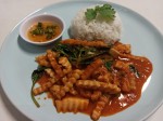 Red curry paste with fried young coconut and basil leaves served with rice Red curry paste with fried young coconut and basil leaves served with rice