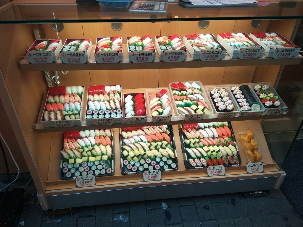 A fake, colorful sushi in front of a restaurant, encourages you to step in and have a great meal. A fake, colorful sushi in front of a restaurant, encourages you to step in and have a great meal.