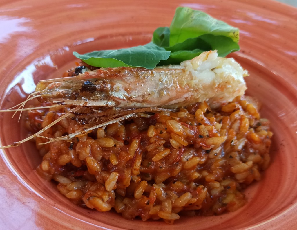 Red rice risotto with prawns and parmesan cheese Red rice risotto with prawns and parmesan cheese